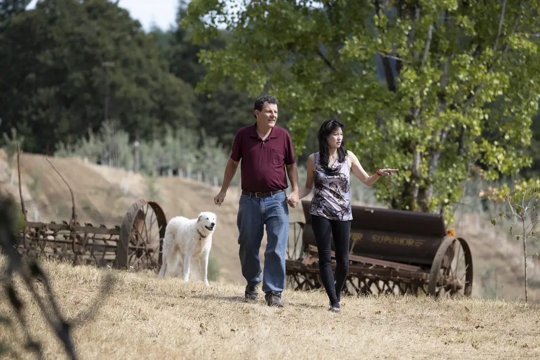 Nicholas Kristof and Sheryl WuDunn walking through the vineyard